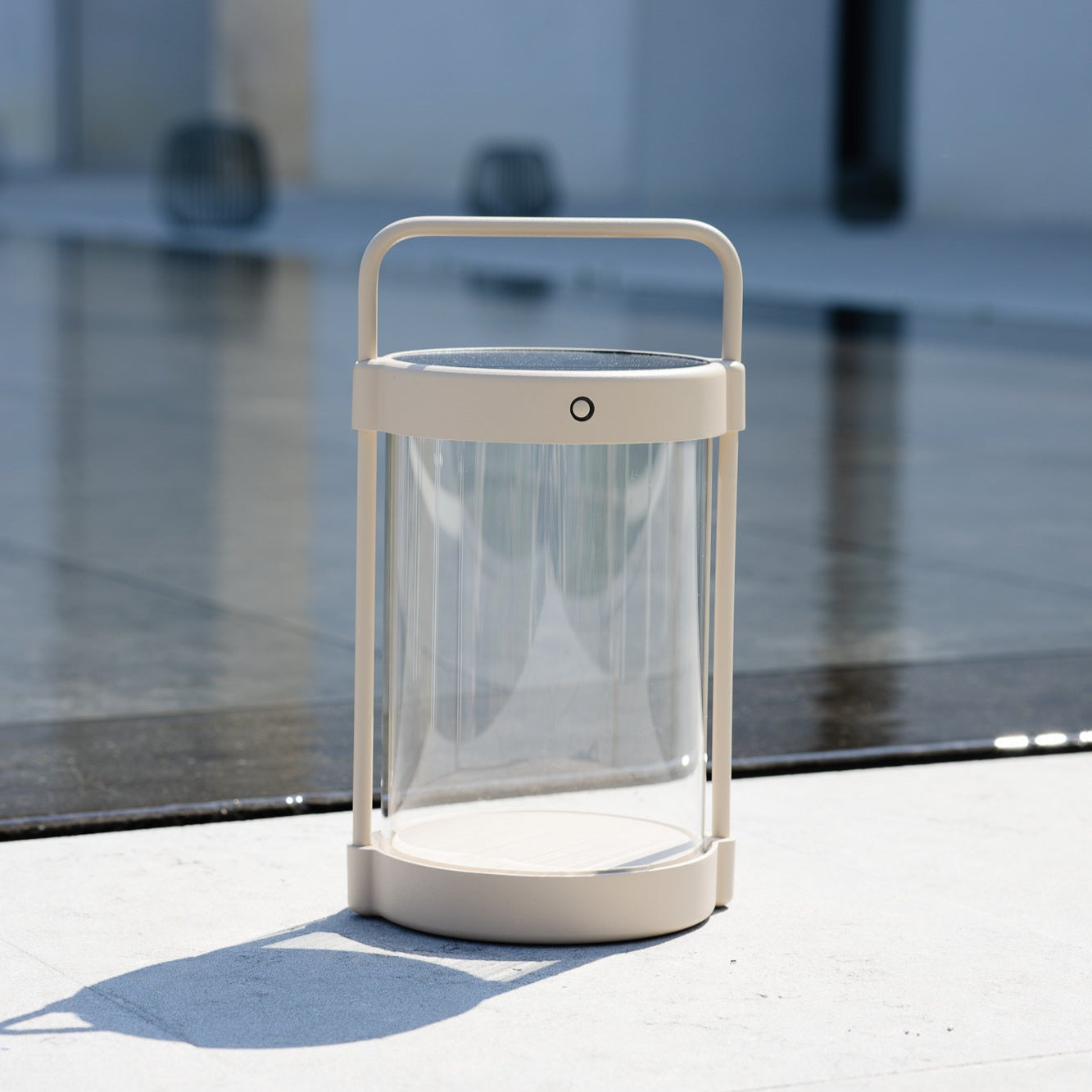 Caia Solarlaterne in Beige mit Echtglas im Tageslicht auf Terrasse – kabelloses Design-Leuchtobjekt für den Außenbereich mit Solaraufladung