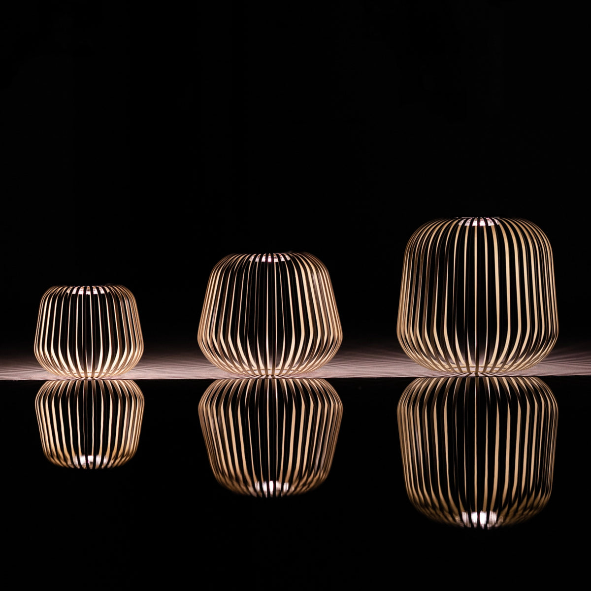 3er Set SOLIS von LUUK Studio in den Größen S, M, L, XL, XXL in Schwarzkirsche bei Nacht mit Spiegelung im Wasser
